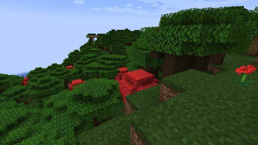 Karanlık bir ormanın ağaç tepelerinin üzerinde duran birçok Minecraft biyomundan biri