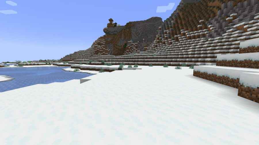 Tepeleri ve donmuş gölü olan karlı bir tundra bölgesi, birçok Minecraft Biyomundan biri