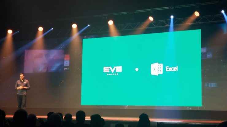 Eve Online kreatif direktörü Bergur Finnbogasson, 'EVE Excel'i seviyor' yazan büyük yeşil bir slaydın yanında duruyor