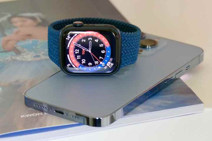 Bir iPhone 13 Pro'nun üzerinde oturan Apple Watch Series 7.