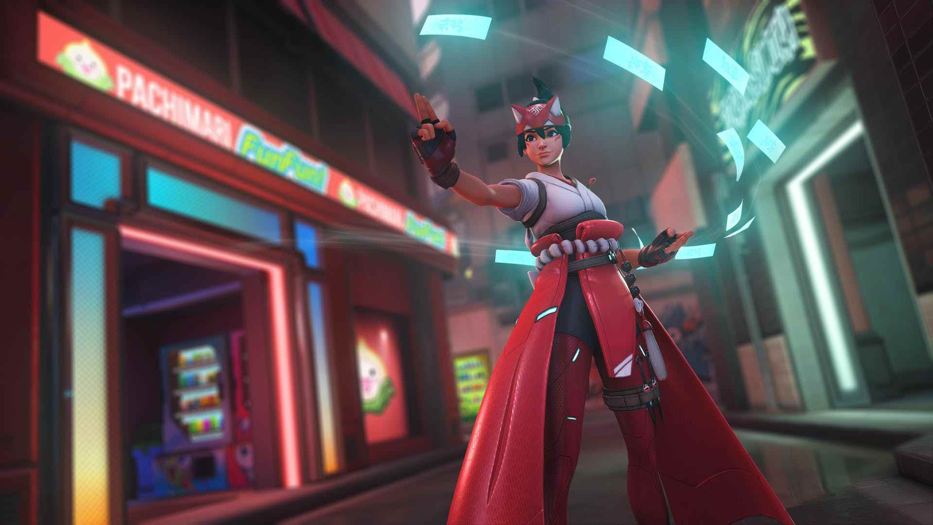 Overwatch 2'den, stilize edilmiş kırmızı ve beyaz bir savaş gi giymiş, büyülü, iyileştirici ve bıçak fırlatan bir Japon tapınak kızı / ninjası olan Kiriko'nun yer aldığı ekran görüntüsü
