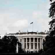 Beyaz Saray uzaktan fotoğraflandı, üzerinde dalgalanan bir Amerikan bayrağı