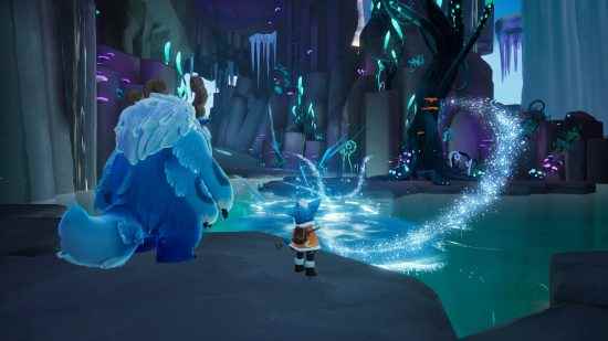 Yanında büyük bir yeti olan küçük bir çocuk, aydınlık bir mağaradaki parlak mavi su havuzuna bakıyor